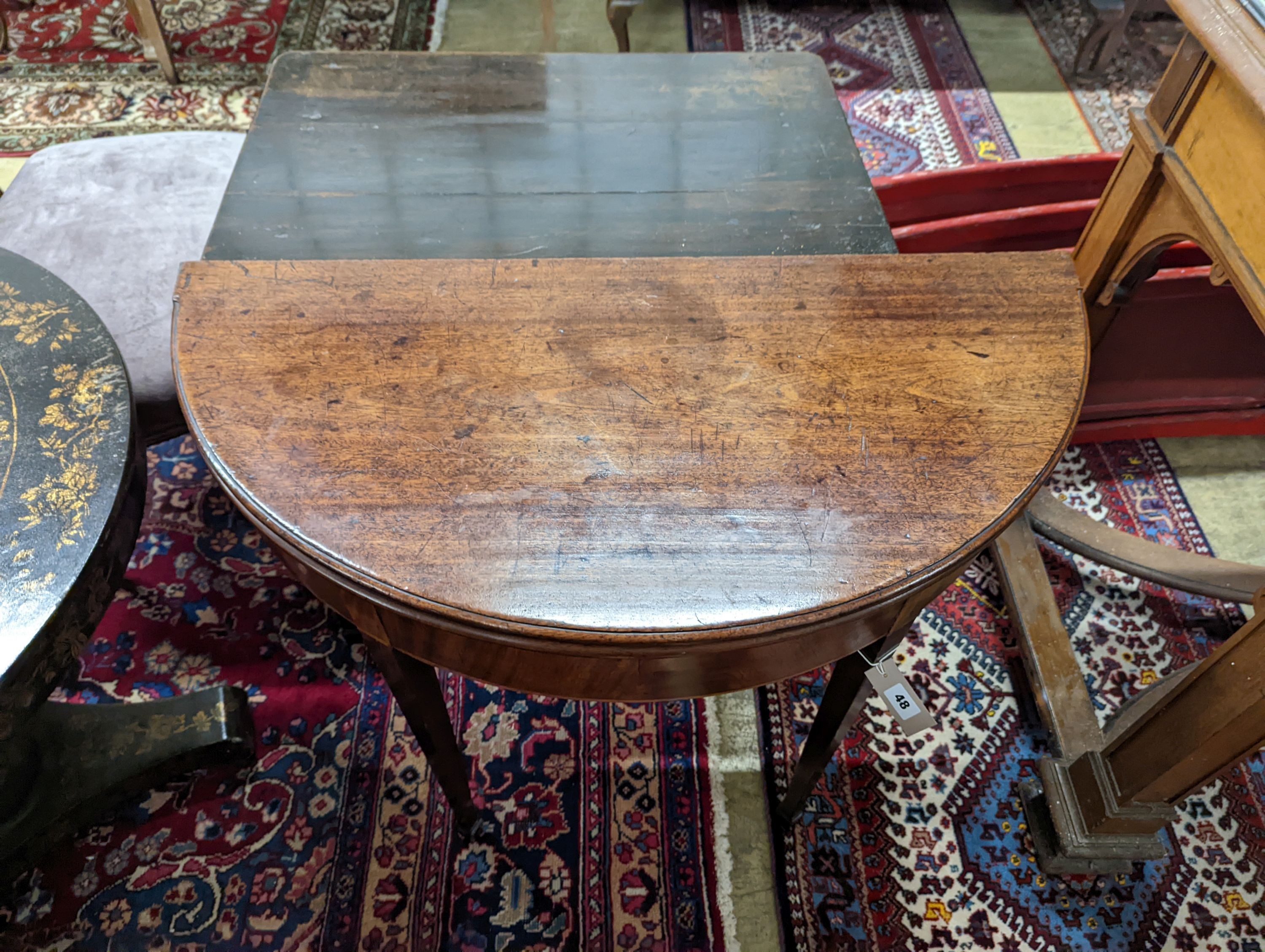 A George III mahogany demi lune tea table. W-90, D-44, H-73cm.